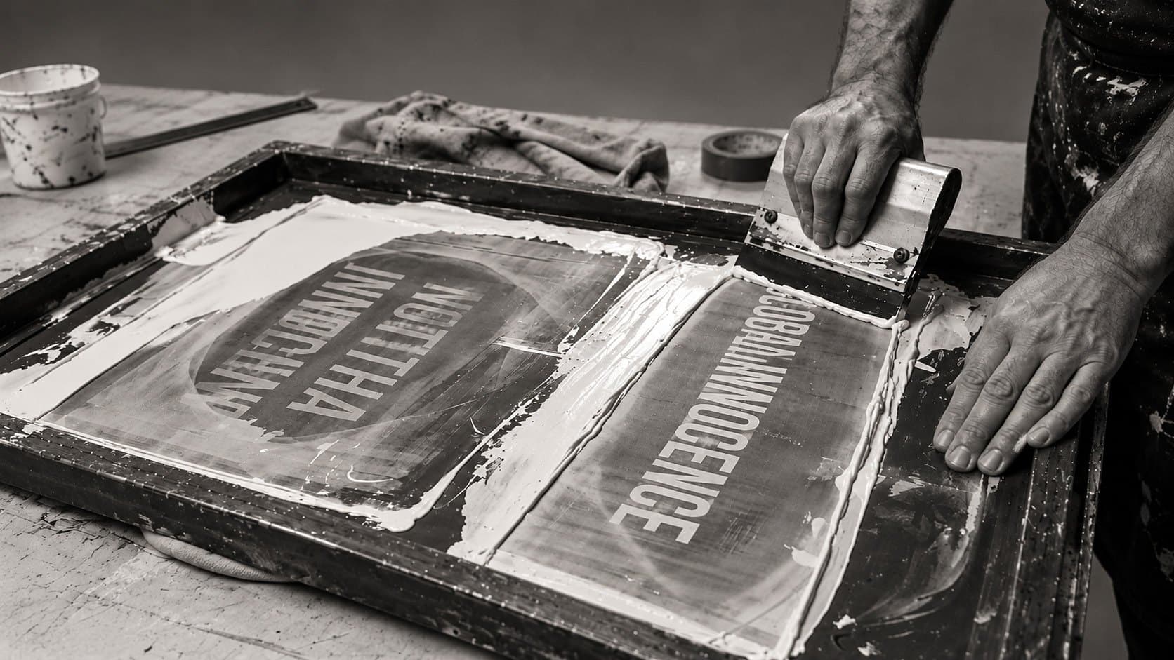 Screen printing in the workshop: the screen with NOT THAT INNOCENT and GLOBAL INNOCENCE.